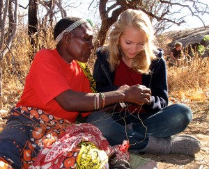 Grauer School student Natalie Brooks (right) works with a tribal member in Tanzania. (Grauer School photo)