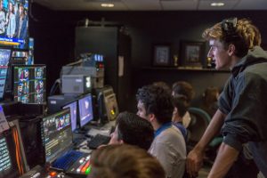 Carlsbad High School Senior Devin Van Siclen (right) oversees a rehearsal of a Carlsbad High School Television (CHSTV) program on Oct. 13. Van Siclen is the acting show producer, guiding the switching between cameras and the cueing of footage. (Photo by Troy Orem)