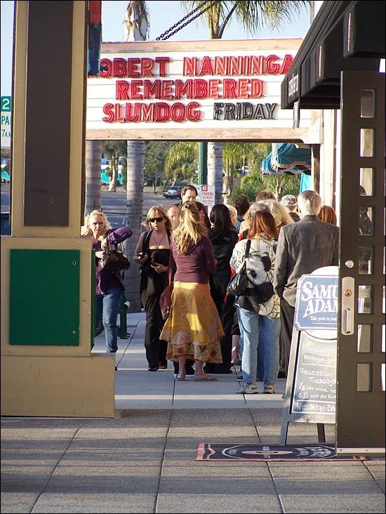 Community members wait outside La Paloma Theatre in Encinitas on March 12 before a memorial for activist and artist Bob Nanninga, who died in February. (Photo by Scott Landheer)