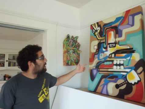 San Diego artist Isaias Crow at his studio home shows one of 17 large pieces he will be exhibiting at Santos Fine Art Galleries in Encinitas. The exhibit is called CROLOS and it will run April 7-30. (Photo by Ernesto Lopez)