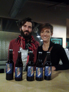 George Thornton and Molly Brooks-Thornton, who run The Homebrewer in North Park, show bottles of Surfing Madonna Beer at Café Ipe on Dec. 12 in Leucadia. They brewed the beer and guests were able to sample it. Bottles were also raffled. (Photo by Ernesto Lopez)