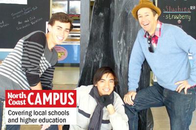 Students George Erie (left) and Scott Lindquist (center) show the mockup of their sculpture with teacher Jeremy Wright (right). (Photo by Helen Hawes)