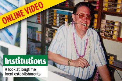 A photo taken in 1991 shows Mark Anderson posing for “Hawaiian Day,” a theme day that the store took part in with local businesses and residents. The photo is part of a collage inside the store that friends and family members put together following his death. (Photo by Scott Allison)