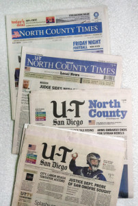Editions of the North County Times and U-T San Diego show the evolution of the papers’ merger. (North Coast Current photo)
