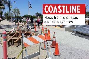 Pedestrians walk around final construction along Highway 101 in Solana Beach in early August. (Photo by Ernesto Lopez)