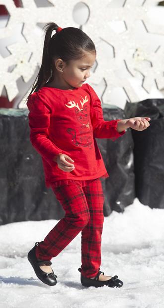 Heyliee Sanchez, 3, plays in the snow field at the event.