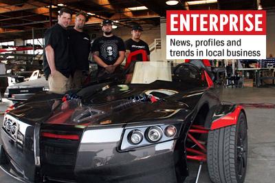 Chris Anthony (far left), Mark Stewart, Ben Trpcerski, Alex Zuniga (far right) stand with a Torq Roadster at the Epic Electric Vehicles shop in Vista. (Photo by Manny Lopez)