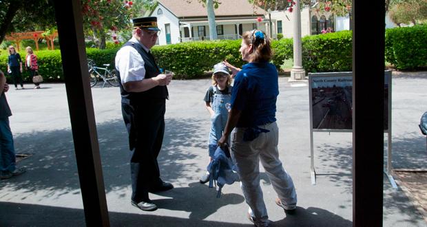 Jay Sarno with NCMRS talks with Edward 10 (who is growing out his hair for Locks of Love) and his mother, Amanda Lehey outside the new location of the  North County Model Railroad Society Museum. 
