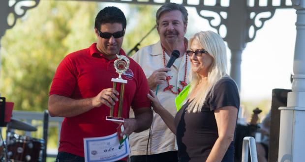 Oceanside Firefighter Bryan Hunt receives the trophy for the firefighters first place chili from Steve Turk and Joan Burns 