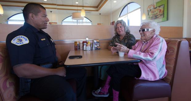 Oceanside Police Officer, Jose Gomez chats with Catherine James and Ione Elsner at the first Oceanside Coffee with a Cop event