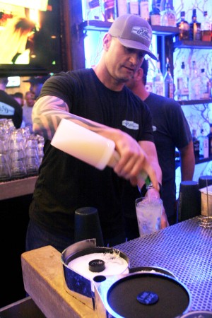 Pillbox Tavern bar manager Ryan Jones prepares signature drinks Dec. 10 during the restaurant’s grand opening. (Photo by Manny Lopez)