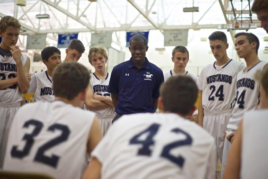 San Dieguito Academy basketball coach Jason Stewart discusses tactics with his team during a timeout at a Dec. 5 game at West Hills High School in Santee. The Mustangs were playing against a team from Box Hill Senior Secondary College, a school located in a suburb of Melbourne, Victoria Australia. (Photo by Troy Orem)