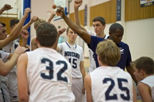 New San Dieguito Academy boys basketball coach Jason Stewart cheers with his team Dec. 5 during a game in Santee. (Photo by Troy Orem)