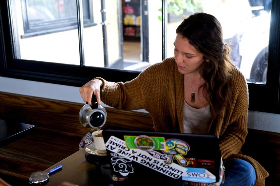 Customer Haley Toon pours her tea at Sugar Coffee & Tea on Feb. 20 in the Encinitas community of Leucadia. “I always get the cucumber green tea, or the chai tea; they have really good chai,” she says. (Photo by Troy Orem)