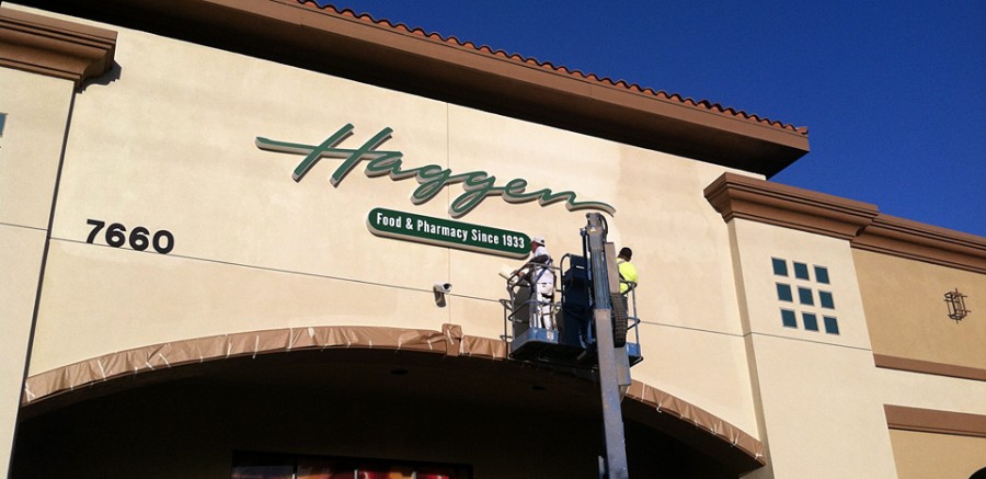 Workers put the finishing touches on a new sign for Haggen market in Carlsbad on March 9. The store, a former Albertsons, is the first for Washington-based Haggen in California. (North Coast Current)