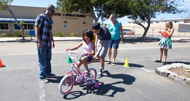 Samantha, 6 tries her new bike on for size.