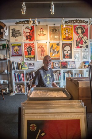 Jerry Waddle, owner of Ducky Waddle’s Emporium, is pictured May 29 among his Leucadia store’s eclectic mix of used books and cutting-edge art. (Photo by Jen Acosta)