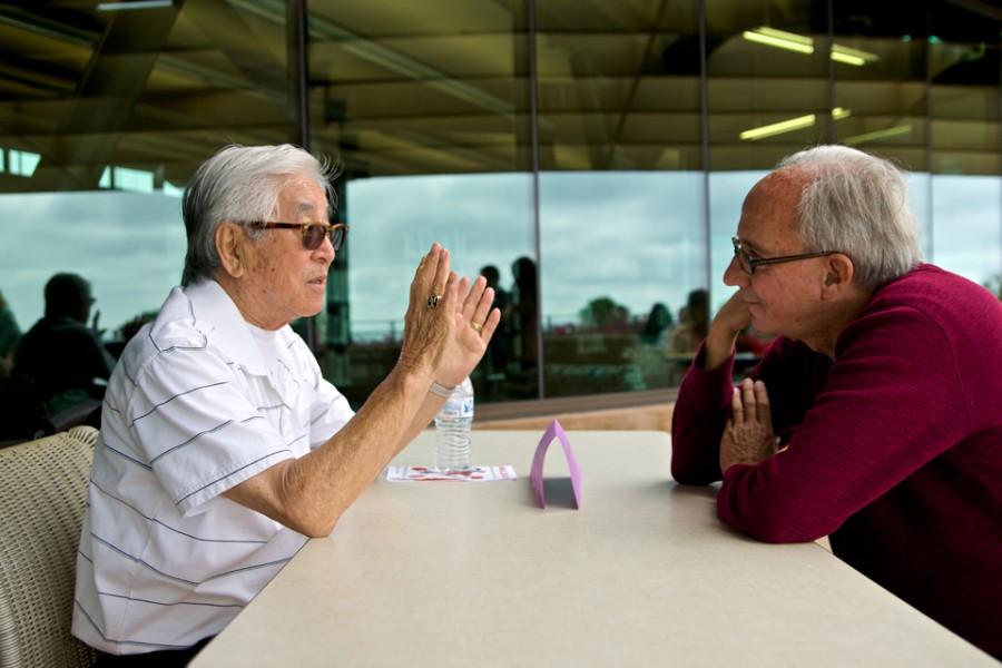 Japanese-American internment camp survivor and local resident Tak Sugimoto (left) speaks with Paul Meardon about his experiences in 1942 when he and his family were sent to a camp during World War II. The discussion was part of the Human Library event held June 7 at the Encinitas Library. (Photo by Troy Orem)