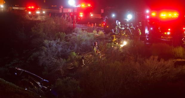 Oceanside Firefighters and Police officers use a rope and pulley system to lift driver to roadway. Photo: Steve Marcotte/OsideNews