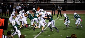 La Costa Canyon High School’s varsity defense attempts to stop Oceanside High School’s play during the Oct. 30 game at Oceanside’s Simcox Field. Oceanside won the game 22-7. (Photo by Troy Orem)