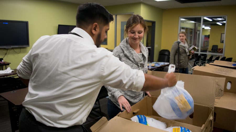 Manny Patino and Alexa Morr sort through the turkeys donated by Mary Ann Moore-Enright 