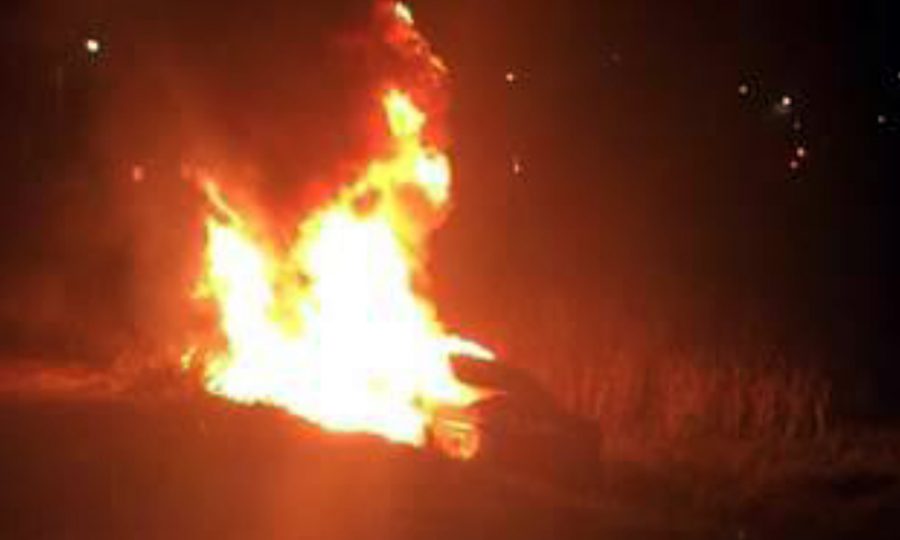 A Honda Civic burns on Manchester Avenue at San Elijo Lagoon in Encinitas early Oct. 23. Sheriffs Deputy Steve Gusman is credited with saving the life of a driver trapped in the car. (San Diego County Sheriffs Department photo)