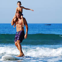 Summertime family surfing. (Photo by Filios Sazeides, Unsplash)