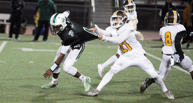 Kyrin Beachem(4) is grabbed by Isaiah Gonzalez(21) after a 45-yard run in the first quarter