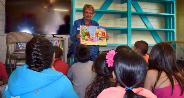 Marlene Samocha reads Christmas stories to the kids at La Casita