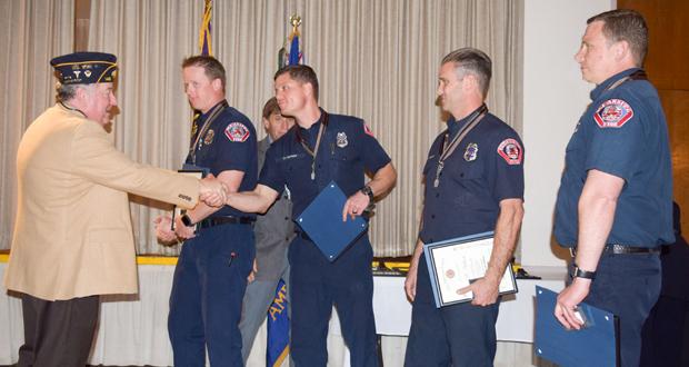 Kevin Johnstone congratulates OFD personell; Captain Justin Klopfenstein, David Pepsny,  J.P. Neilson and Rick Goetz