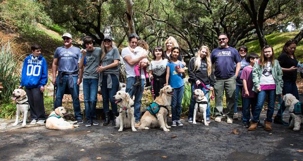 Good Dog! Families, Trainers and Volunteers pose for a group photo in the beautiful meadow of the Lions Gate Estate, Fallbrook (Photo courtesy: Laura Sylvester)