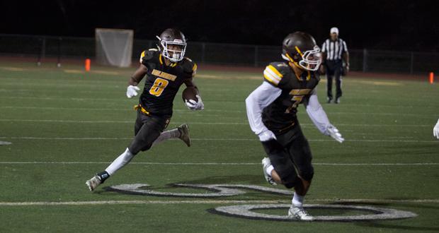 Jordan Wilkins(8) follows Payton Whiteside(7) on the final drive of the game.