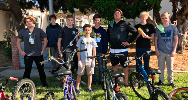 Members of the San Dieguito Academy Boys Water Polo Team at their Bike Drive benefitting the Encinitas Community Resource Center’s Holiday Baskets event. From L-R: Jude Irons, Eli Anderson, Alex Glenn, Ben Wieland, Michael Wieland, Matheus Gensler, Vinnie Whibbs and Blake Brandley. (Courtesy photo)