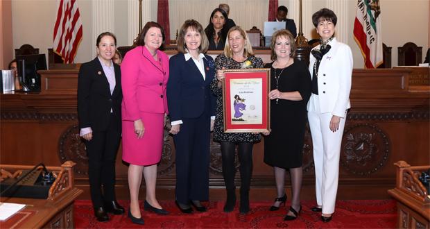 Front row from left to right: Lieutenant Governor Eleni Kounalakis; Senate President pro Tem Toni Atkins; Sen. Patricia Bates; Woman of the Year Honoree Lisa Rodman; Senate Republican Leader Shannon Grove; and Sen. Connie Leyva, Chair of the Legislative Women’s Caucus. Photo taken by Lorie Shelley inside the State Capitols Senate Chamber in Sacramento.