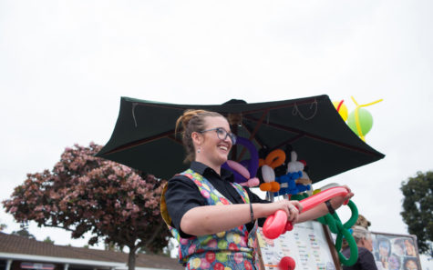 Cori, a professional balloon artist, creates a sword at the Encinitas Street Fair on Sunday, April 28. Cori has been a balloon artist for 12 years. (Photo by Cam Buker)