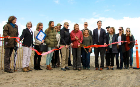 Encinitas Mayor Catherine Blakespear (center) cuts the ribbon for the Cardiff State Beach Living Shoreline project's opening May 22. Encinitas City Councilman Joe Mosca (standing third to the right from Blakespear) was among the various local, regional and state officials on hand for the event. (Nature Collective photo)
