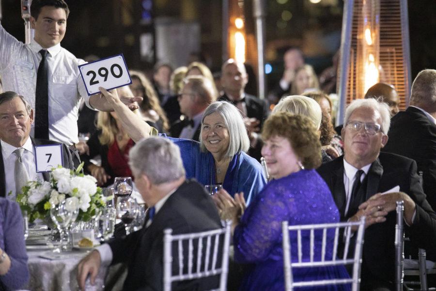 Philanthropist Darlene Marcos Shiley raises her paddle during Cal State San Marcos’ annual fundraising gala on June 8. At the event, Shiley announced that she has donated $2.6 million to the CSU Institute for Palliative Care. (CSUSM photo by Andrew Reed)