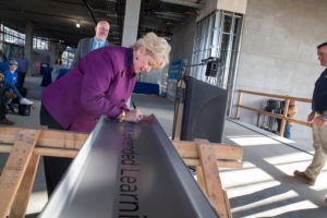 CSU San Marcos President Karen Haynes signs a beam during a “topping out” ceremony for the university’s new Extended Learning building on Nov. 16, 2018. (CSUSM photo by Christine Vaughan)