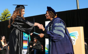 MiraCosta College President Sunita Cooke (right) congratulates a graduate May 24 at the Oceanside campus. (MiraCosta College photo by Alex Karvounis)