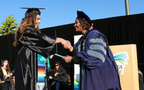 MiraCosta College President Sunita Cooke (right) congratulates a graduate May 24 at the Oceanside campus. (MiraCosta photo by Alex Karvounis)