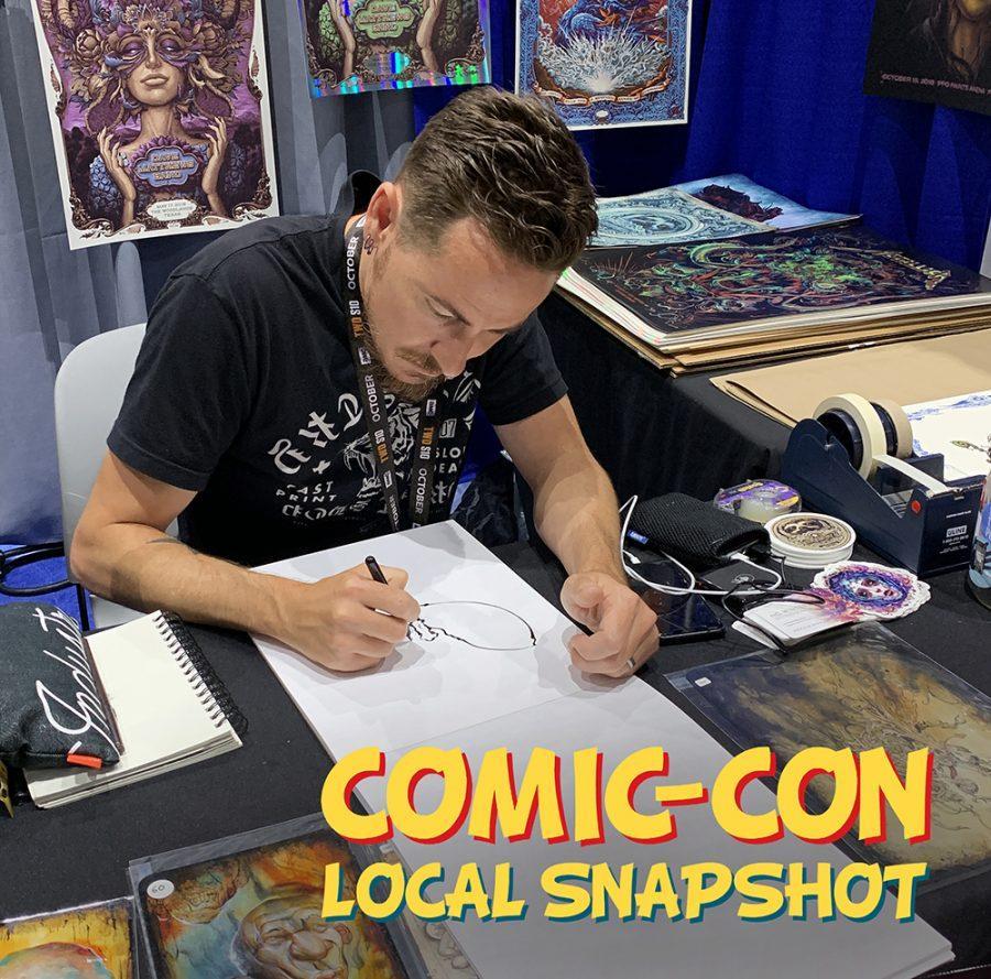 Carlsbad+artist+N.C.+Winters+draws+a+sketch+for+fan+Susie+Lum+of+La+Mirada+at+his+Comic-Con+booth.+The+convention+ran+July+18-21+in+downtown+San+Diego.+%28Photo+by+Meghan+Lanigan%29