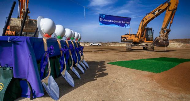 Shovels and hard hats equipped with swim goggles set up for the groundbreaking