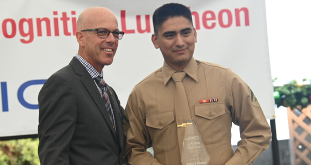 Retired U.S. Navy Command Master Chief David Dearie presents Corporal Zachary Martinez with the 2019 Making a Difference Award during the Fleet Week Enlisted Recognition Luncheon at SeaWorld. (courtesy photo)