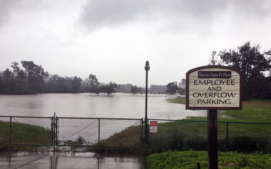 A swollen Escondido Creek flows west through Olivenhain toward San Elijo Lagoon in Cardiff as nonstop rain flooded Encinitas and the region Friday afternoon, April 10. (Photo by Roman S. Koenig)