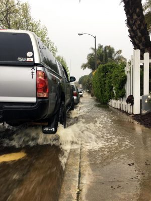 Water rushes downhill north on Cerro Street in Encinitas on Friday afternoon, April 10, as rain inundated San Diego County. (Photo by Roman S. Koenig)
