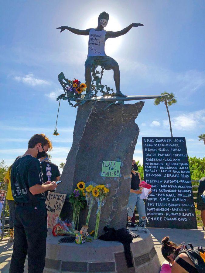 Encinitas residents gather under the Cardiff Kook statue on May 31 to protest the death of George Floyd in Minneapolis. (Photo courtesy of Scott Chatfield)