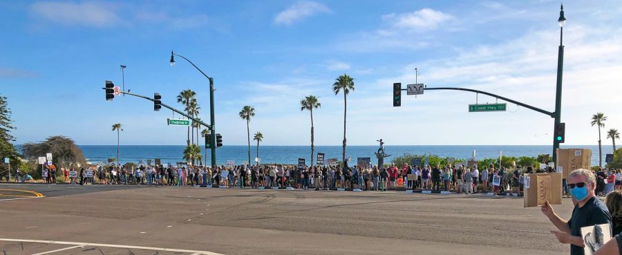 About 200 Encinitas residents gather at the Cardiff Kook statue May 31 to add their voices to growing nationwide protests over the death of an African-American man in Minneapolis police custody. (Photo courtesy of Scott Chatfield)