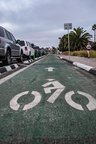 A pedestrian walks along the side of a new dedicated bike line, pictured looking north toward Chesterfield Drive in Cardiff on Wednesday, June 10. (Photo by Jen Acosta)