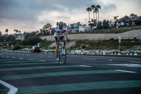 A cyclist rides through a portion of Encinitas’ new protected bike lane in Cardiff on Wednesday, June 10, where riders can transition in and out of the automobile lane. (Photo by Jen Acosta)