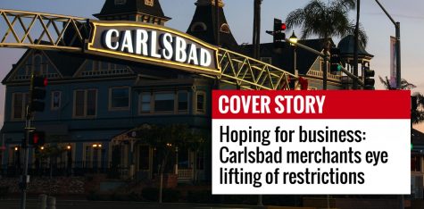The historic Twin Inns building is shown at sunrise behind Carlsbad’s downtown sign. (Photo by Art Wager, iStock Getty Images)
